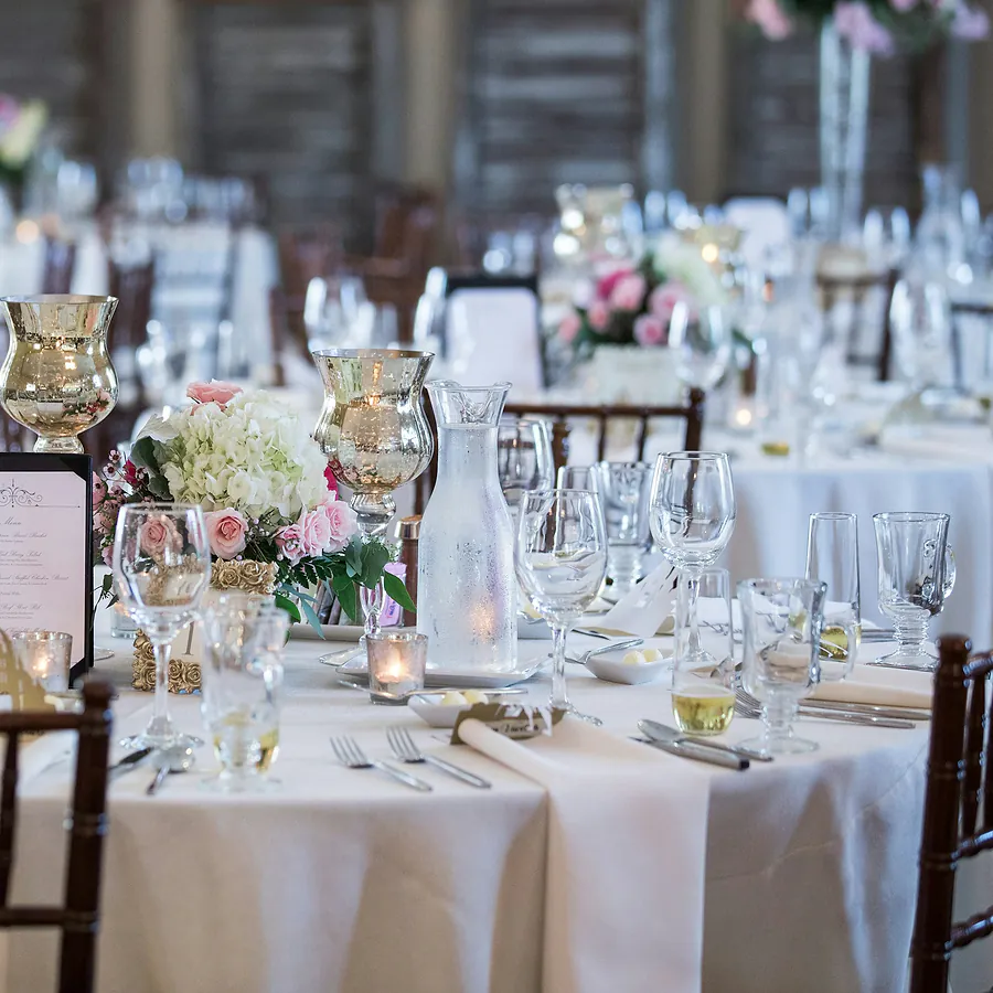 Round reception tables with white linen and pink florals