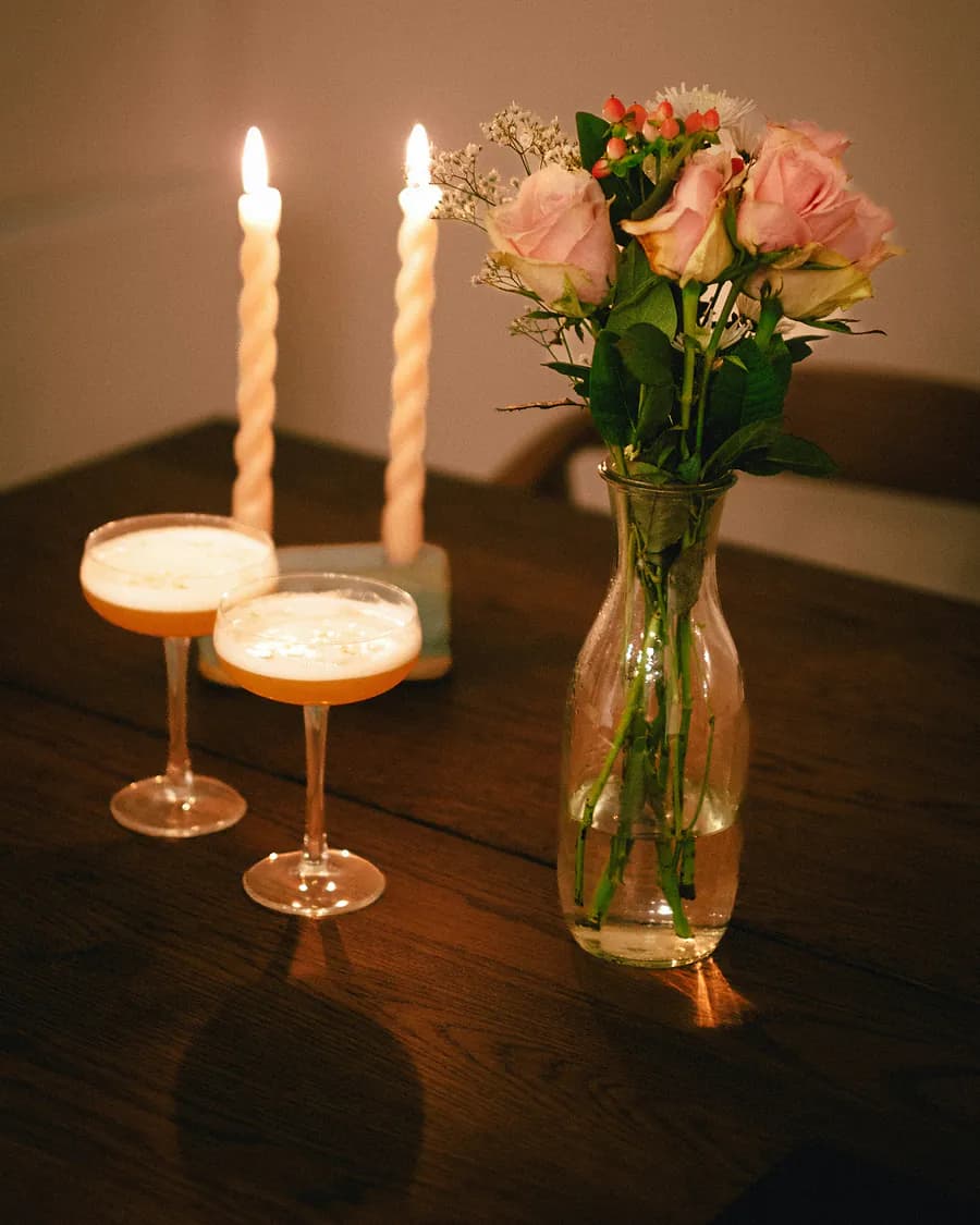 Pink roses and twisted candles on a dinner table